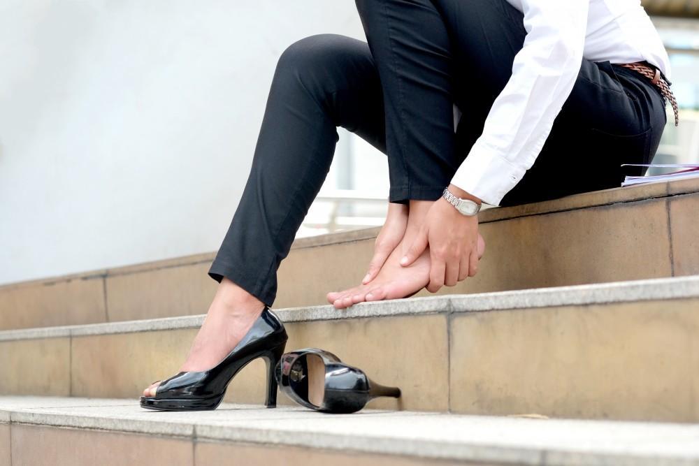 Woman with heel pain from shoe